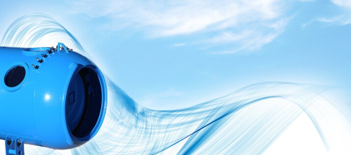 Abstract blue wave design with light sky background.