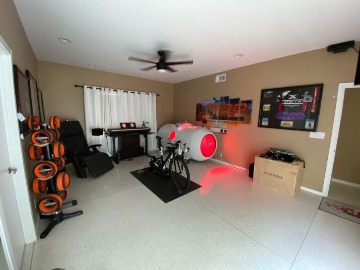 A home music studio with guitars and a drum set.